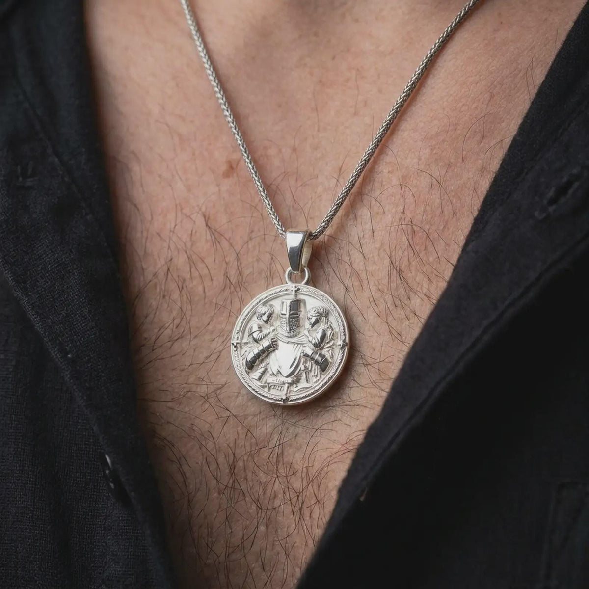 Polished silver Templar knight pendant worn on the chest, featuring a protective warrior embracing two children, Christian cross details, and a dimensional medieval guardian medallion.