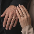 Load image into Gallery viewer, Rose gold plated 925 sterling silver matching bear signet rings worn on the fingers of a man and woman together, highlighting fierce open-mouthed bear heads, detailed fur textures, geometric hexagonal frames, and coordinated rose gold plated finishes.

