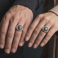 Load image into Gallery viewer, Oxidized 925 sterling silver matching roaring bear signet rings worn on the fingers of a man and woman together, featuring fierce bear heads, open mouths, sculpted fur, hexagonal frames, and coordinated dark oxidized silver finishes.
