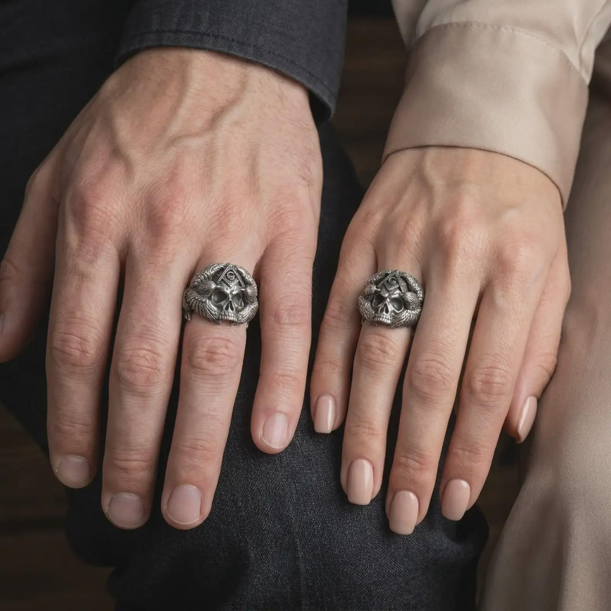 Oxidized sterling silver Masonic skull ring worn on a finger, showing the prominent skull face, Square and Compasses symbol with the letter G, and elaborate eagle wing details along the sides.