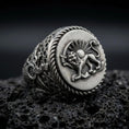 Load image into Gallery viewer, Oxidized sterling silver Persian Lion and Sun signet ring on black volcanic rock, featuring the historic Shir o Khorshid emblem, sword-bearing lion, radiant sun, and twisted rope border.
