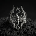 Load image into Gallery viewer, Oxidized sterling silver Skyrim Dragonborn ring on black volcanic rock, featuring the iconic dragon emblem with sweeping wings, an elongated serpentine neck, and an openwork fantasy design.
