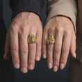 Load image into Gallery viewer, Gold plated eldritch horror Cthulhu ring worn on the finger, highlighting the monstrous octopus-like face, raised forehead, curling tentacles, and bold H. P. Lovecraft-inspired fantasy jewelry design.
