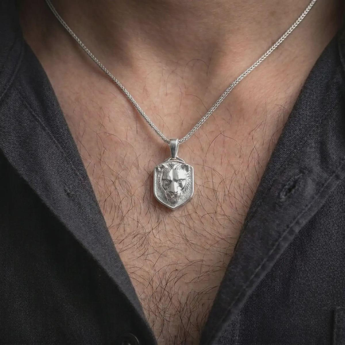 Polished silver lioness necklace worn on the chest, featuring the dimensional lioness head sculpture, expressive eyes, realistic feline contours, and bold wildlife-inspired pendant frame.
