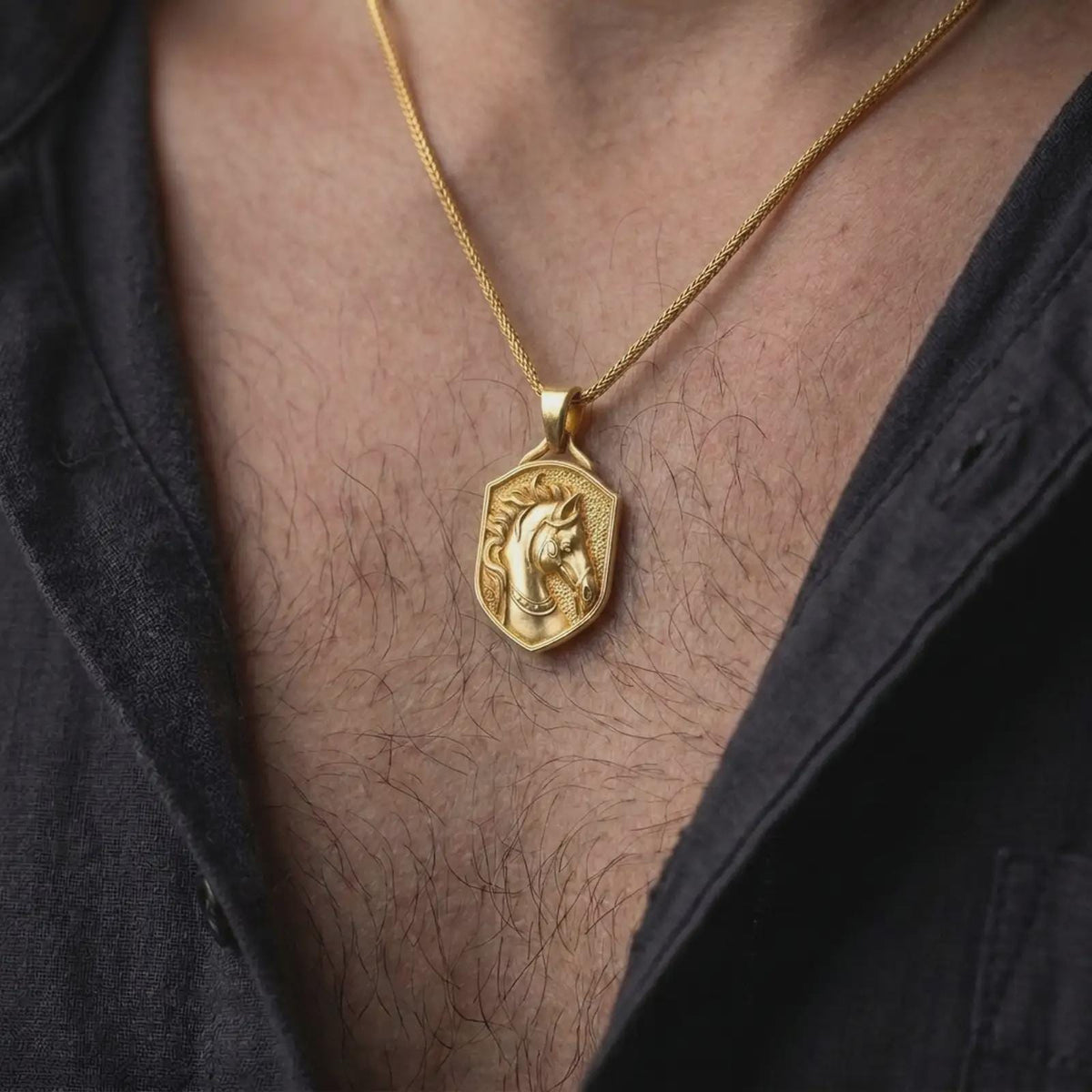 Gold plated horse head pendant worn around the neck, highlighting the sculpted horse with elegant flowing mane, decorative bridle straps, textured shield frame, and distinctive horse lover jewelry design.