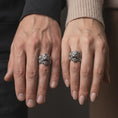 Load image into Gallery viewer, Oxidized sterling silver tiger ring worn on the finger, showing the dramatic roaring tiger face, sharp teeth, dimensional fur carving, and substantial statement band.
