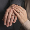 Load image into Gallery viewer, Rose gold plated sterling silver matching rose floral rings worn on the fingers of a man and woman together, highlighting dimensional rose blossoms, detailed botanical engravings, and coordinated romantic rose gold finishes.
