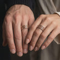 Load image into Gallery viewer, Rose gold plated 925 sterling silver matching Valknut Viking bands worn on the fingers of a man and woman together, highlighting repeating Norse triangular motifs, detailed geometric engravings, and coordinated rose gold finishes.
