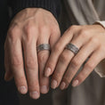 Load image into Gallery viewer, Oxidized 925 sterling silver matching Valknut Viking rings worn on the fingers of a man and woman together, featuring raised Norse triangle symbols, dark textured backgrounds, and coordinated oxidized silver finishes.
