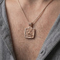 Load image into Gallery viewer, Rose Gold Plated Saint George Orthodox necklace displayed on a man's chest, emphasizing the Greek inscriptions and cross-shaped pendant frame.
