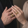 Load image into Gallery viewer, Gold plated 925 sterling silver matching octopus tentacle rings worn on the fingers of a man and woman together, featuring flowing octopus arms, detailed suction cups, sculpted sea creature designs, and coordinated warm gold plated finishes.
