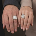Load image into Gallery viewer, Polished 925 sterling silver matching St Nicholas of Myra rings worn on the fingers of a man and woman together, showcasing detailed Catholic bishop figures, ornate religious vestments, three-ball books, rectangular signet frames, and bright polished silver finishes.
