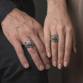 Load image into Gallery viewer, Oxidized 925 sterling silver matching roaring bear head rings worn on the fingers of a man and woman together, featuring fierce three-dimensional bear portraits, open jaws, sharp fangs, detailed fur, and coordinated dark oxidized silver finishes.
