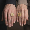 Load image into Gallery viewer, Gold Plated Saint Peter and Paul rings displayed on the fingers of a man and woman together, featuring the rectangular Catholic signet design.
