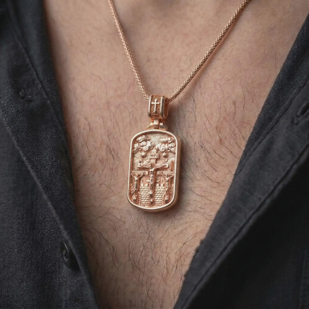 Rose Gold Plated Three Crosses religious necklace displayed on a man's chest, emphasizing the detailed Calvary scene and decorative clouds.