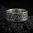 Load image into Gallery viewer, Oxidized Silver Valknut ring on black volcanic rock, featuring a stylized Norse triangular knot and intricate Asanoha geometric patterns.
