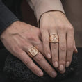 Load image into Gallery viewer, Rose Gold Plated Saint Cecilia Catholic rings worn by a man and woman together, emphasizing the rectangular religious relief and ornate cross motifs.
