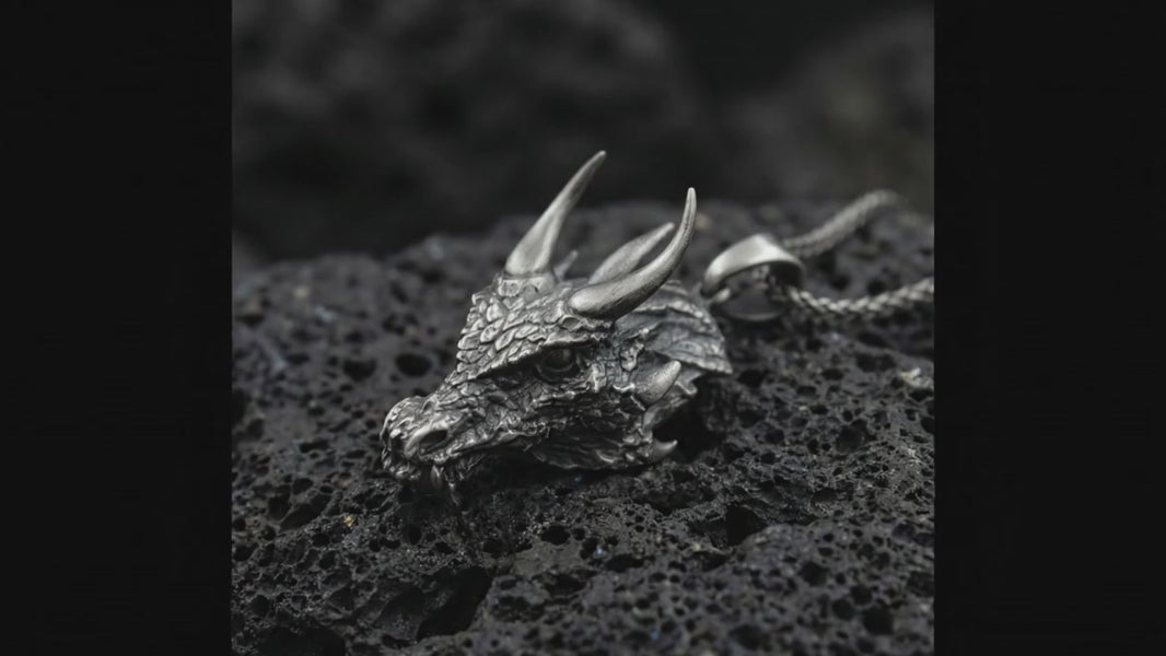 Dragon head pendant necklace on volcanic stone background Detailed dragon head jewelry with sculpted horns and scales Mythical dragon talisman pendant high detail macro shot